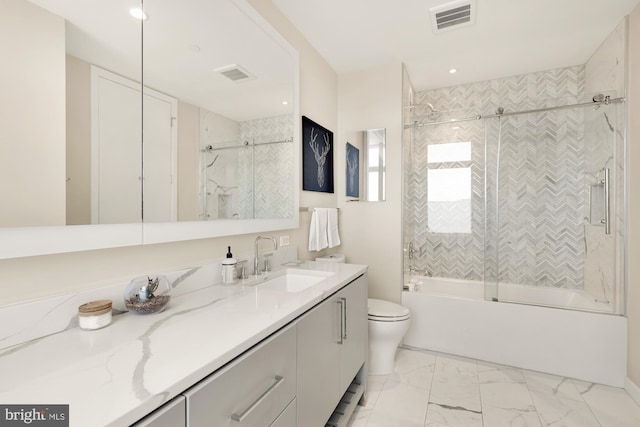 full bathroom with enclosed tub / shower combo, vanity, and toilet