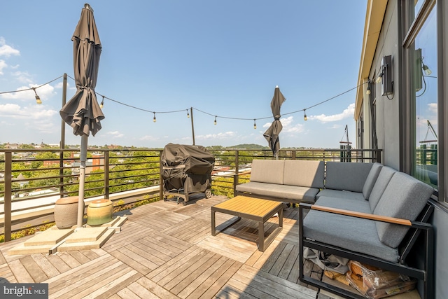 wooden deck with grilling area and an outdoor hangout area