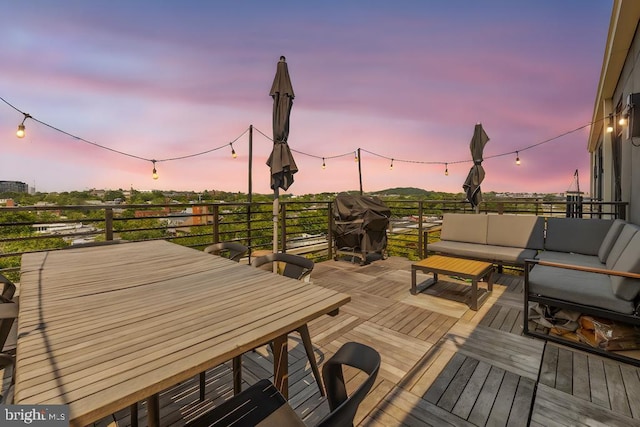 deck at dusk with an outdoor living space