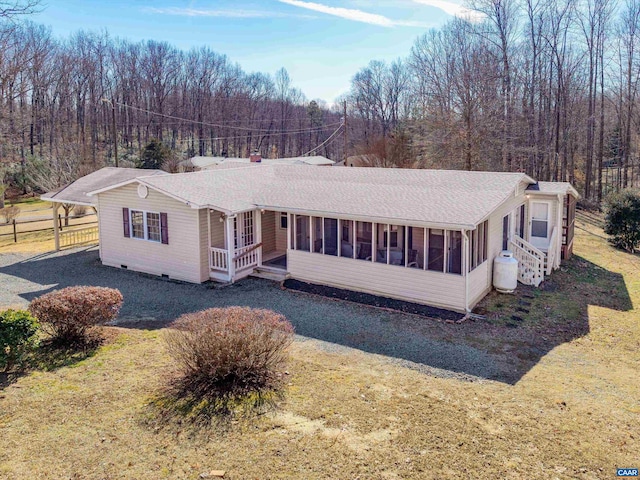 view of front of property featuring a sunroom and a front yard