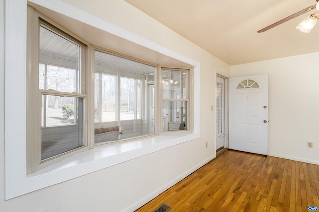 interior space with hardwood / wood-style floors and ceiling fan