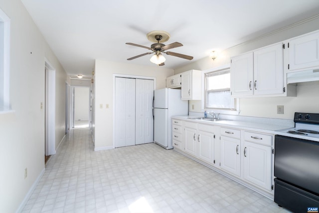 kitchen featuring white refrigerator, sink, white cabinets, and electric stove