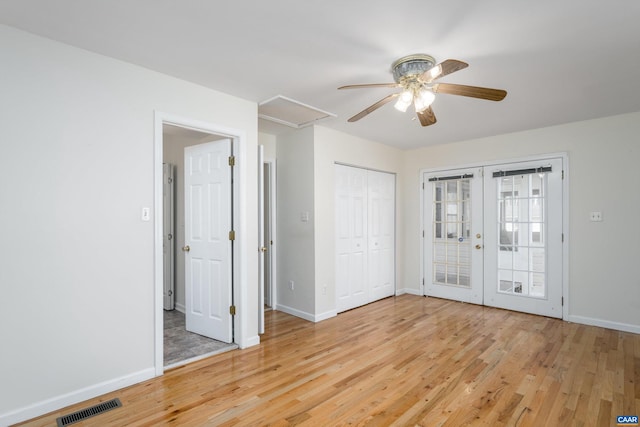 empty room with light wood-type flooring and french doors