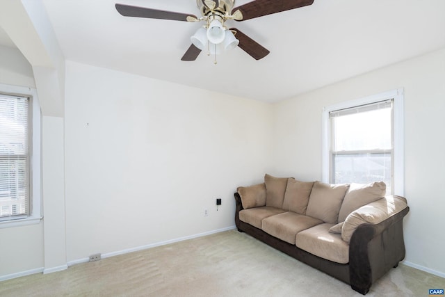 living room with light carpet and ceiling fan