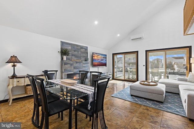 dining space featuring a tiled fireplace, a wall mounted air conditioner, and high vaulted ceiling