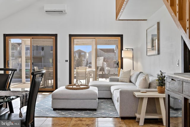 living room featuring tile patterned floors, lofted ceiling, and a wall unit AC