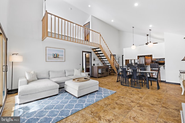 living room with high vaulted ceiling and ceiling fan