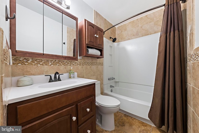 full bathroom with vanity, tile walls, shower / bath combination with curtain, and toilet