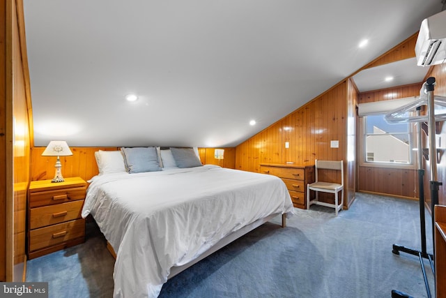 bedroom with lofted ceiling, wooden walls, a wall mounted AC, and dark colored carpet