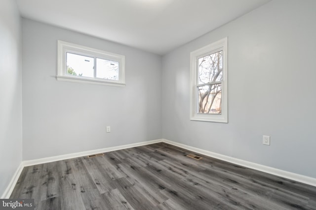 unfurnished room featuring dark wood-type flooring