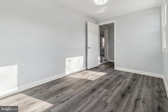 unfurnished room with dark hardwood / wood-style floors