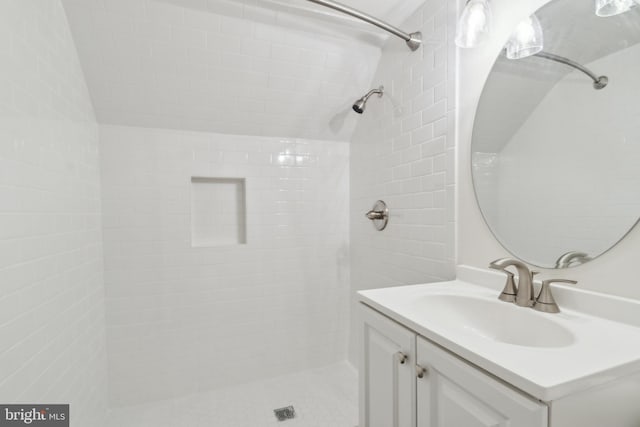 bathroom featuring vanity and a tile shower