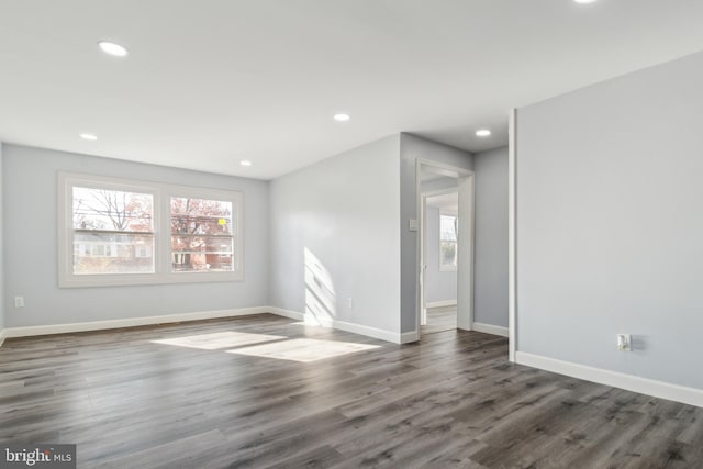 spare room with dark hardwood / wood-style flooring