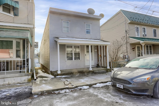 front of property with a porch and cooling unit