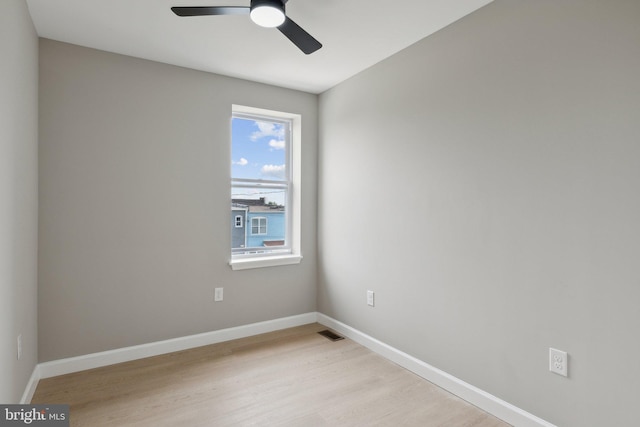 empty room featuring ceiling fan and light hardwood / wood-style flooring