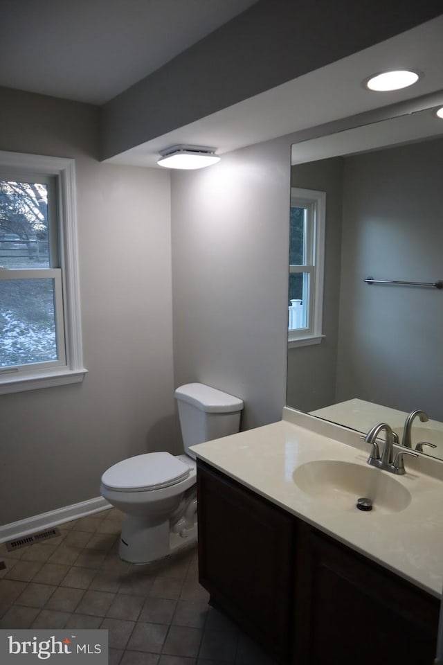 bathroom with tile patterned flooring, vanity, and toilet