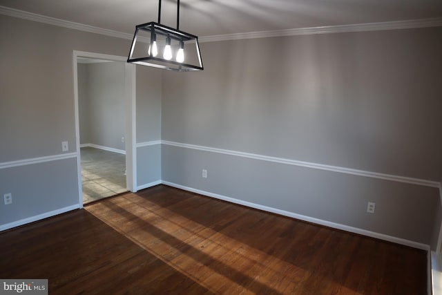 unfurnished dining area featuring ornamental molding and dark hardwood / wood-style flooring