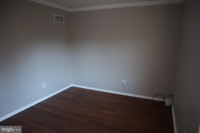 unfurnished room with crown molding and dark hardwood / wood-style floors