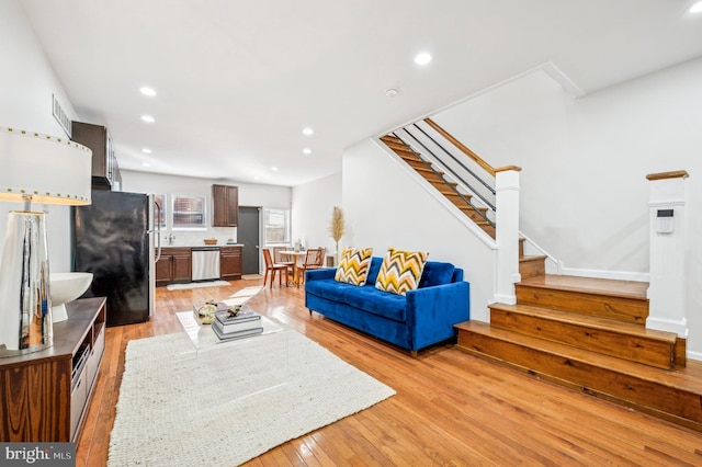 living room featuring sink and light wood-type flooring