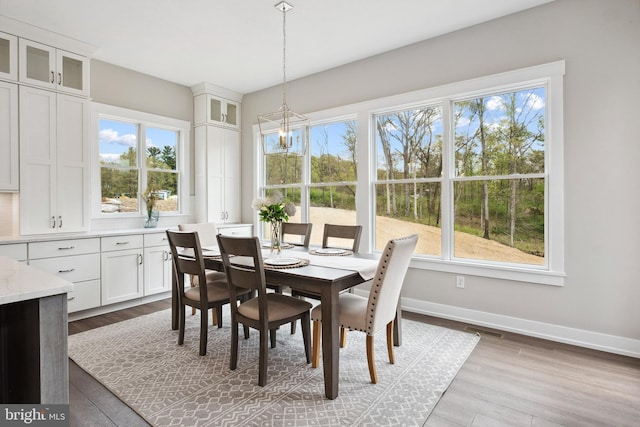 dining area featuring an inviting chandelier and wood-type flooring