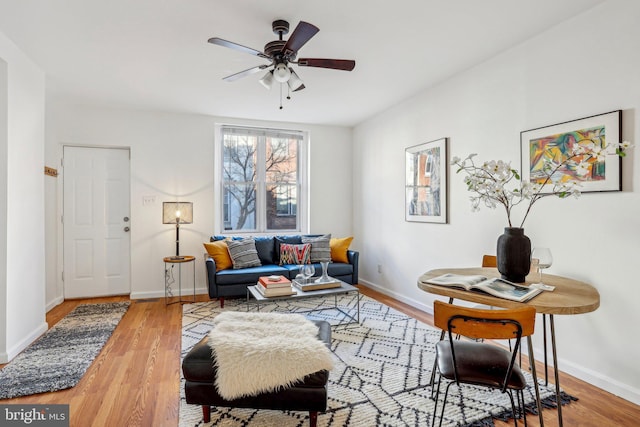 living room featuring ceiling fan and wood-type flooring