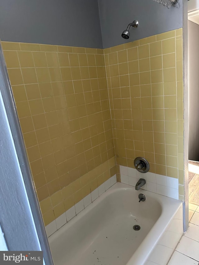 bathroom with tiled shower / bath and tile patterned floors