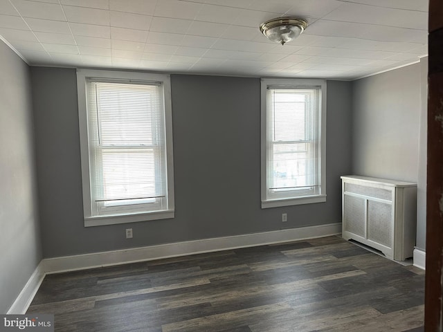 unfurnished room featuring dark hardwood / wood-style floors