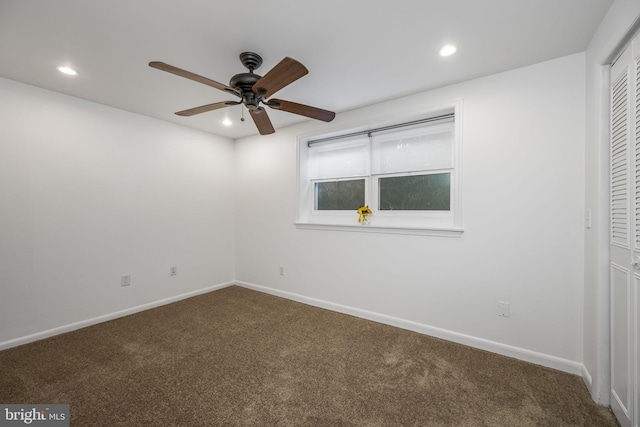 carpeted spare room featuring ceiling fan