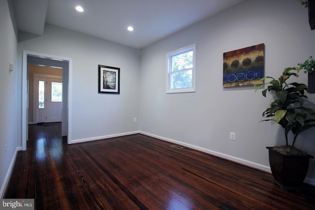 spare room featuring dark hardwood / wood-style floors and a wealth of natural light