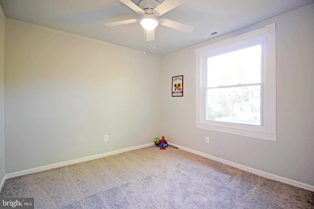 empty room with ceiling fan and carpet