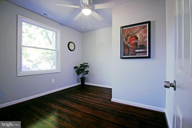 empty room featuring dark hardwood / wood-style flooring and ceiling fan