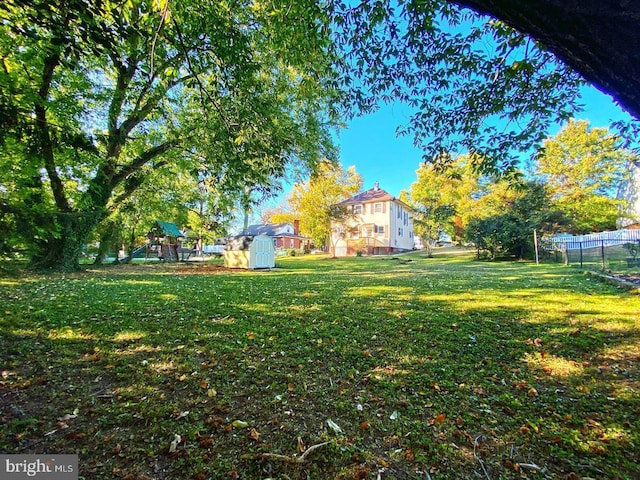 view of yard with a shed and a playground