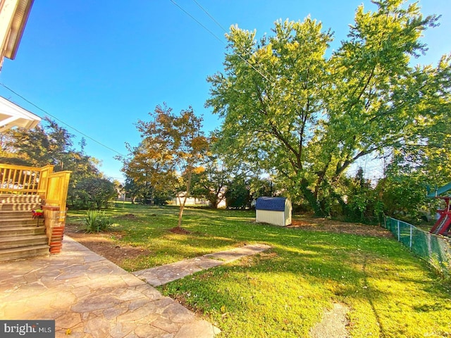 view of yard featuring a shed and a patio