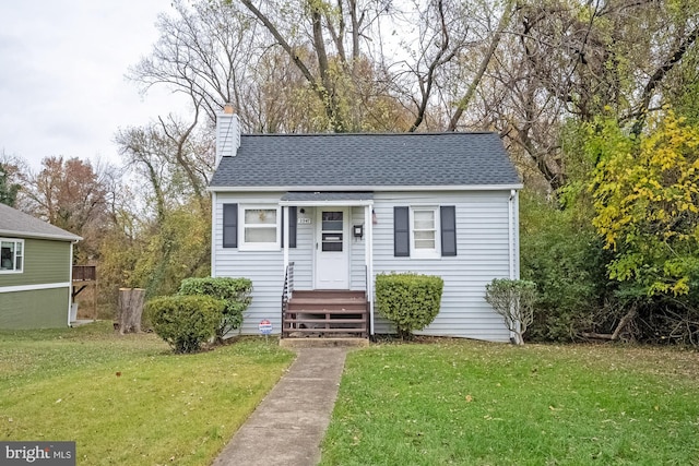 bungalow-style home featuring a front yard