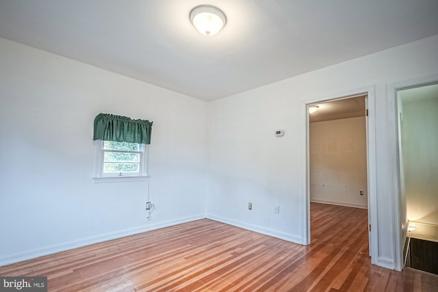 spare room with hardwood / wood-style flooring