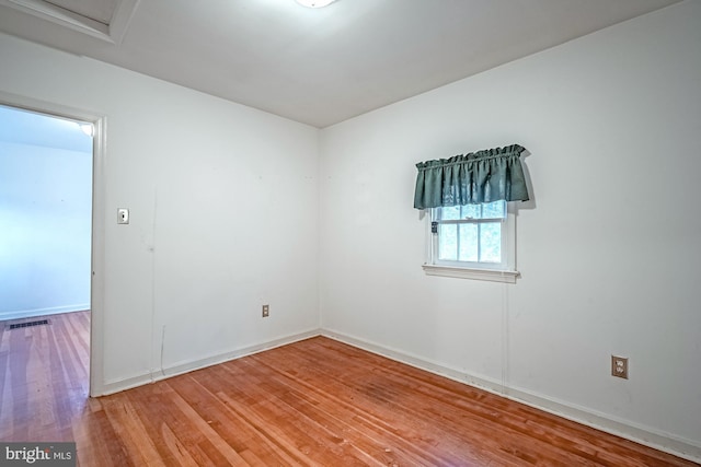 empty room with hardwood / wood-style floors