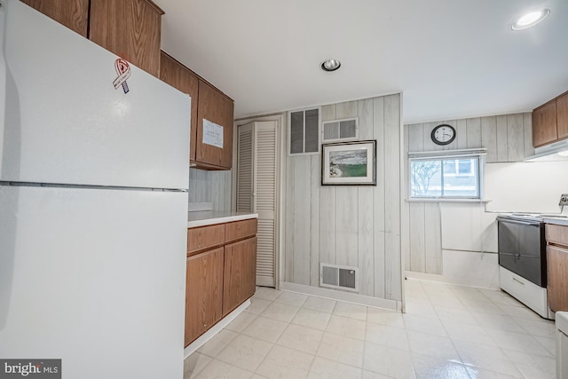 kitchen featuring range with electric stovetop and white refrigerator