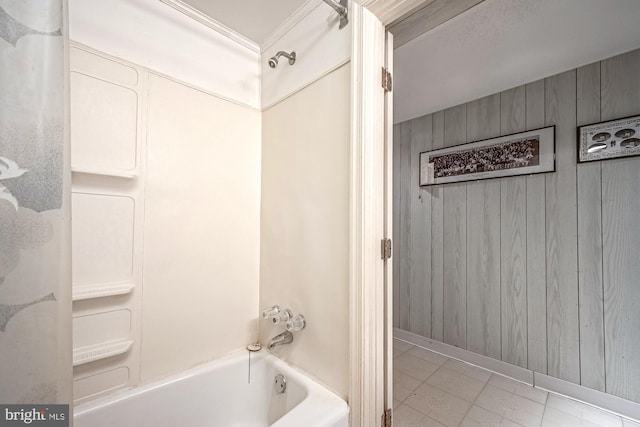 bathroom featuring shower / washtub combination and wood walls