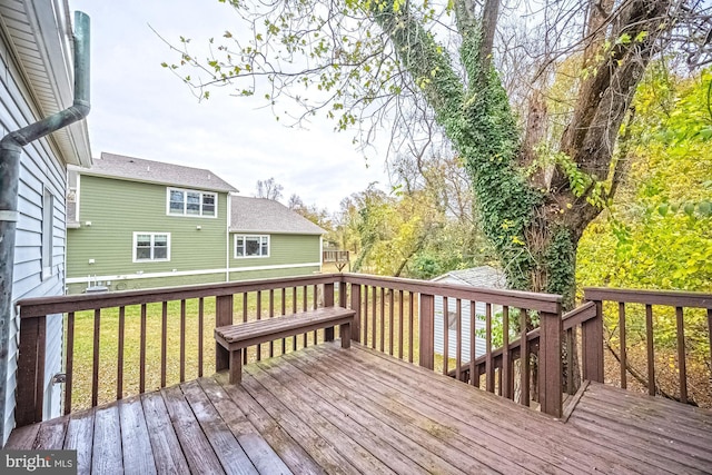 wooden terrace featuring a lawn