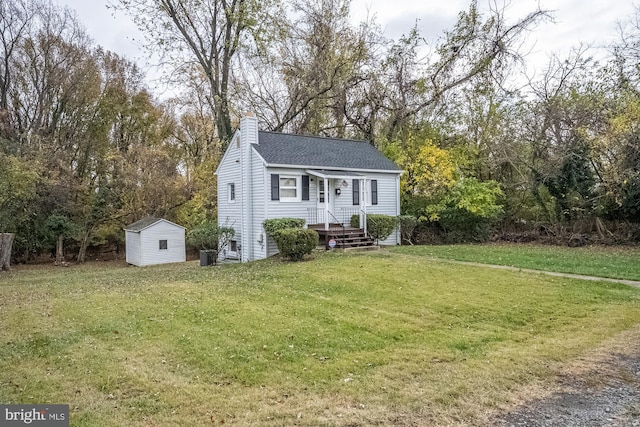 view of front of home with a front yard and a shed