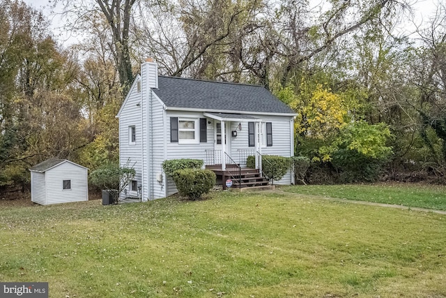 view of front of home with a front lawn and a storage shed