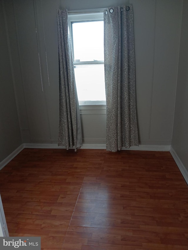 spare room with hardwood / wood-style flooring