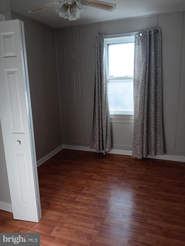 unfurnished room featuring hardwood / wood-style floors and ceiling fan