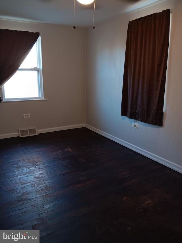 empty room with dark wood-type flooring