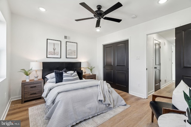 bedroom with light hardwood / wood-style flooring and ceiling fan