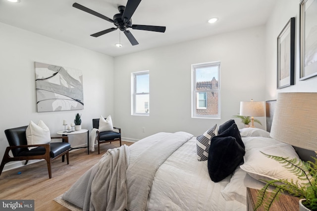 bedroom with ceiling fan and light hardwood / wood-style flooring