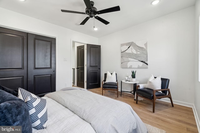 bedroom with ceiling fan and light wood-type flooring