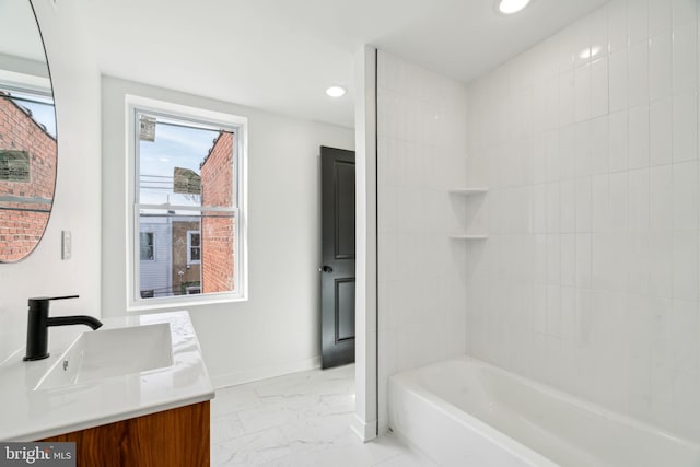 bathroom featuring vanity and tiled shower / bath combo