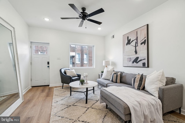 living room featuring ceiling fan and light hardwood / wood-style flooring