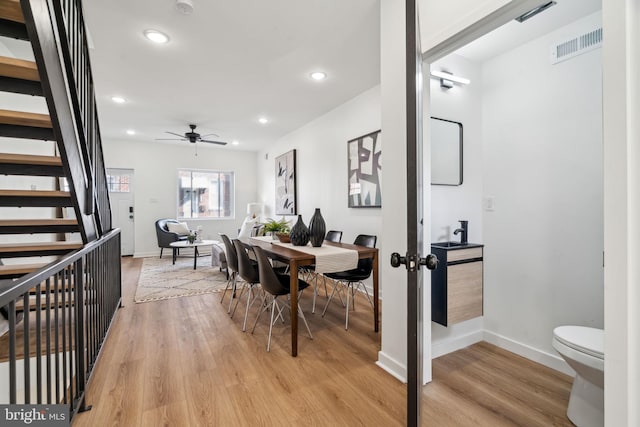 dining space featuring ceiling fan and light hardwood / wood-style floors